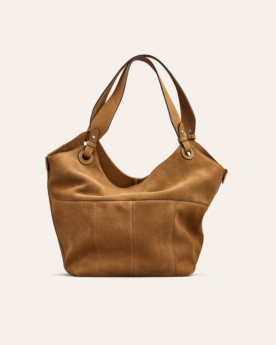 Brown leather handbag on a light beige background